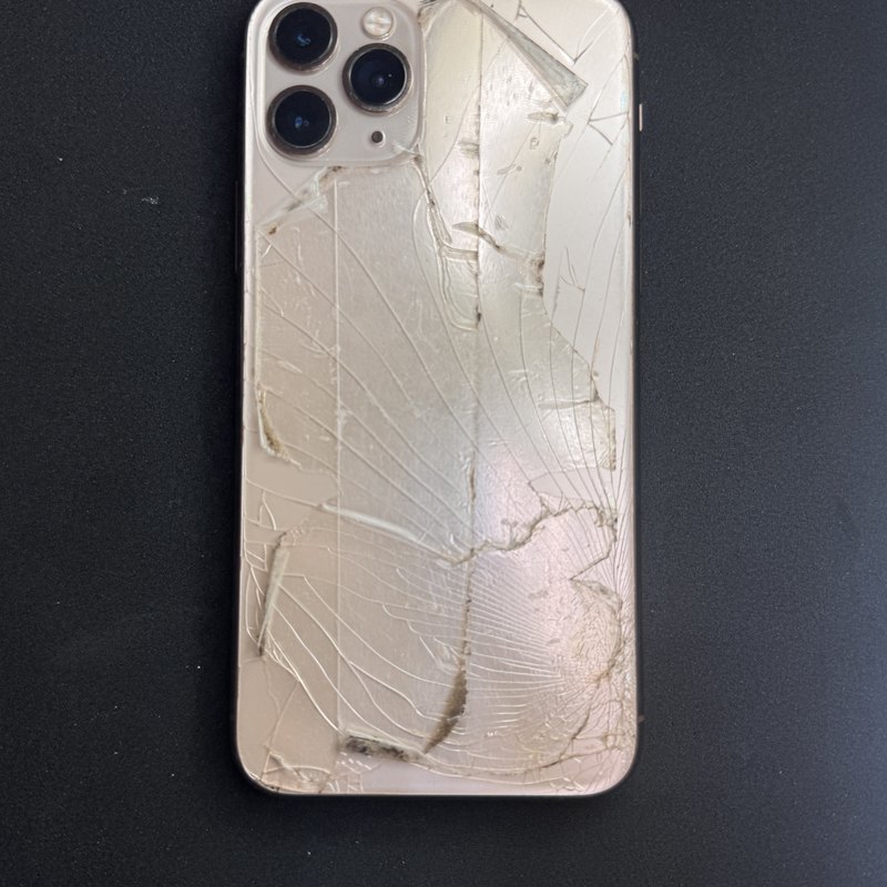 iPhone 11 Pro with the rear glass panel shattered across the whole back